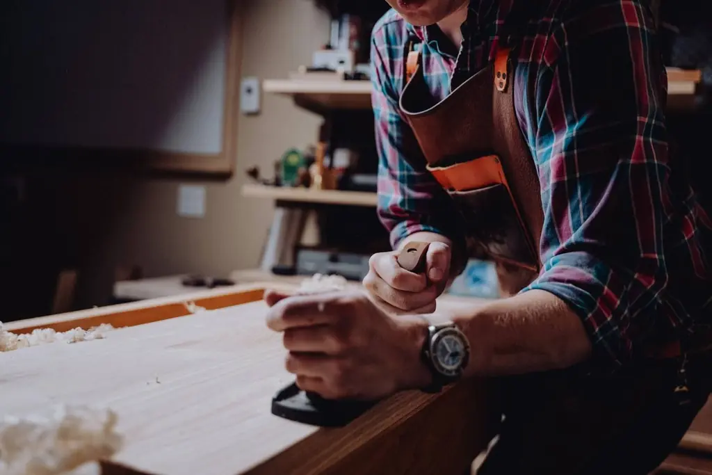 Close-up of a joiner working on timber in the workshop