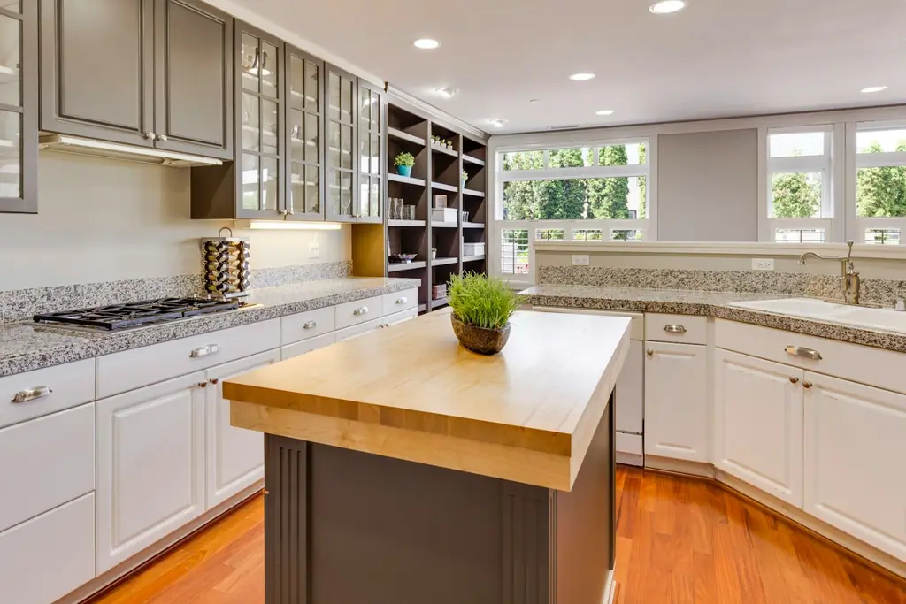 The finished kitchen with a solid timber island and open shelving